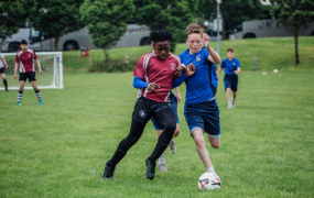 CBS students jostle for the ball.