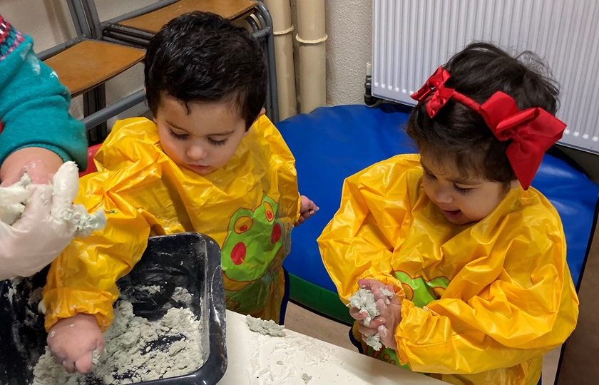 Two children doing arts and crafts as part of EDNIP